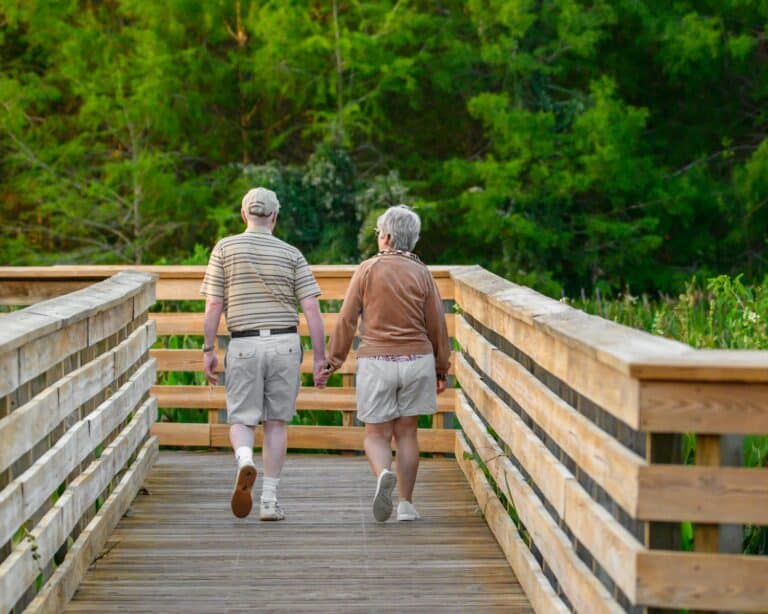 a couple of people that are walking across a bridge
